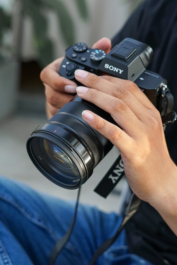 Close Up Photo of a Person Holding Black Camera